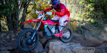Stark VARG electric dirt bike ridden over rocks on a technical enduro trail.