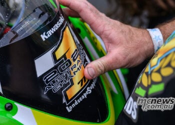 Close-up of a 2026 Australian Champion number one sticker being placed on Tom Edwards’ Kawasaki.