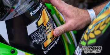 Close-up of a 2026 Australian Champion number one sticker being placed on Tom Edwards’ Kawasaki.