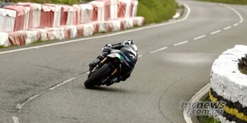 Rear view of Michael Dunlop leaning the Paton S1-R-650 through a bend at the Isle of Man TT.