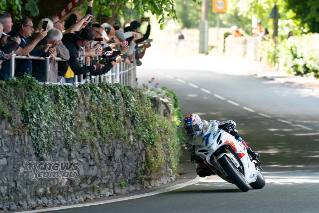 Josh Brookes leans the Uggly & CO Racing Suzuki R750 close to the wall during the 2026 Supersport TT Race 1.