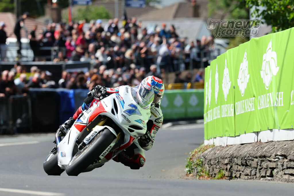 Josh Brookes rides the number 7 Suzuki R750 through a right-hand section of the TT Mountain Course.
