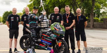 Michael Dunlop poses with his winning Ducati Panigale V2, trophy and team after Supersport TT Race 1.