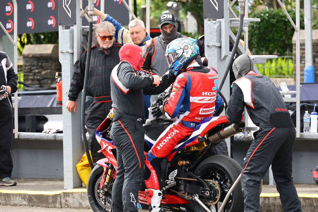 Dean Harrison sits on the Honda CBR600RR during his Supersport TT Race 1 pit stop.