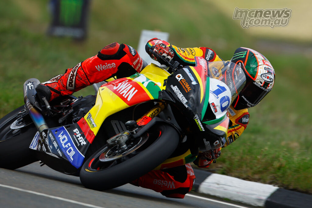 Close-up of Peter Hickman leaning the number 10 Swan Racing Triumph during Supersport TT Race 1.