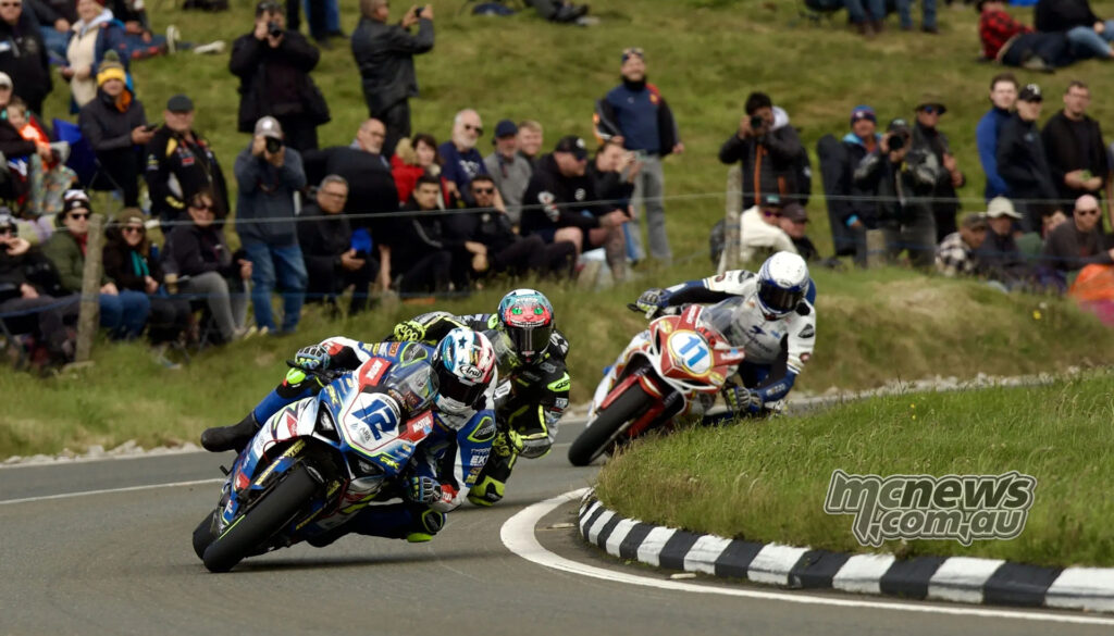 Ian Hutchinson leads Conor Cummins and other riders through a sweeping section of the TT Mountain Course.