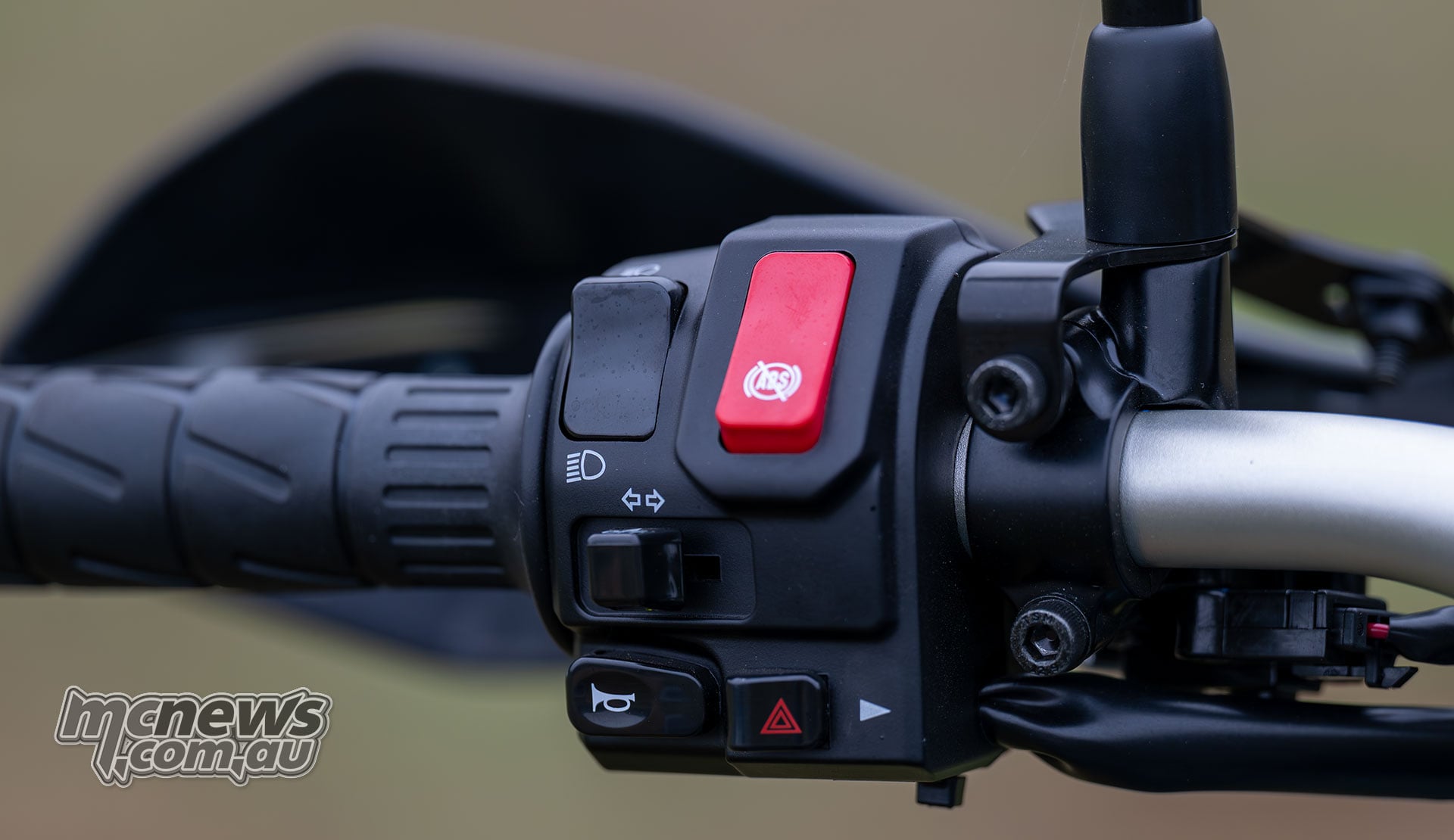 Kawasaki KLE500 SE left handlebar switchgear with a red ABS button above the indicator and horn controls.
