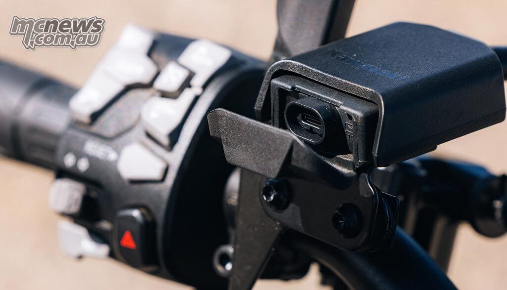 Close-up of the Kawasaki Z1100 SE ABS USB-C charging port beside the left handlebar switchgear.