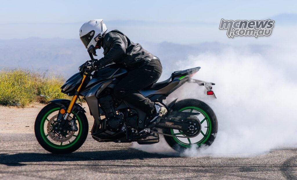 Side view of a rider performing a burnout on the 2026 Kawasaki Z1100 SE ABS with smoke pouring from the rear tyre.