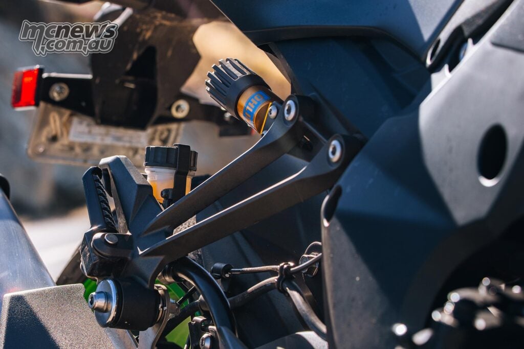 Close-up of the Kawasaki Z1100 SE ABS rear suspension adjuster, brake reservoir and rear subframe area.