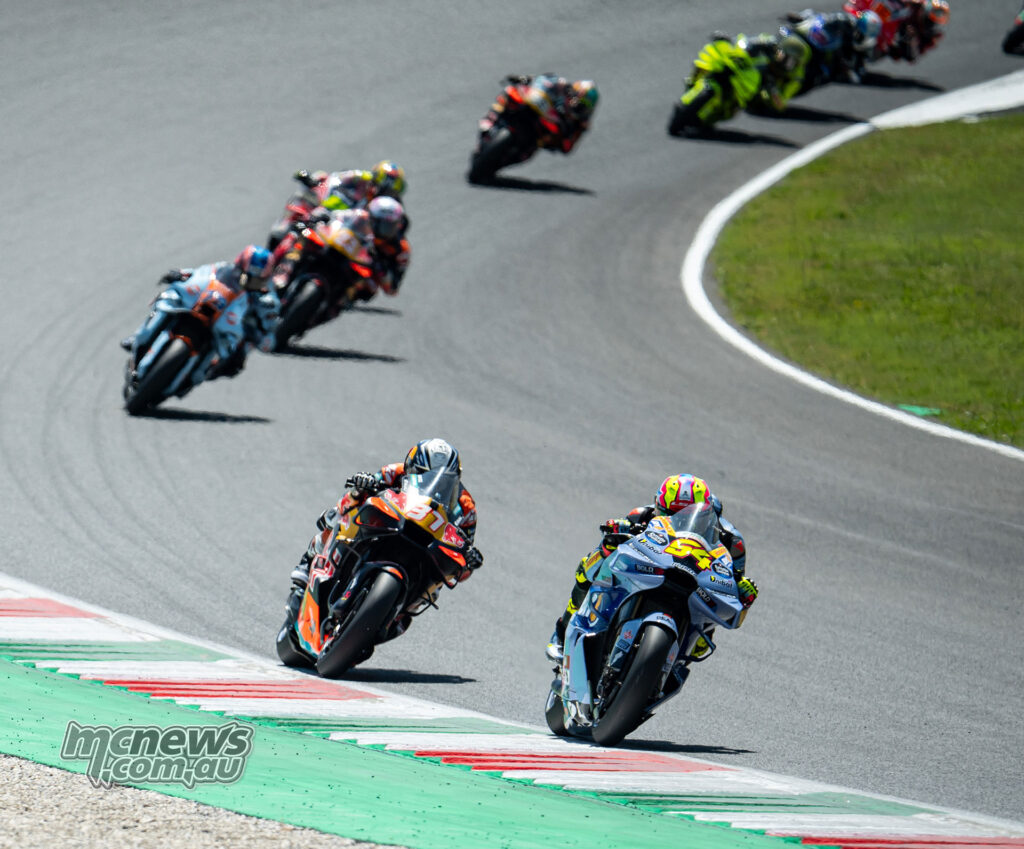 Fermin Aldeguer leads Pedro Acosta through a Mugello corner with the MotoGP pack behind.