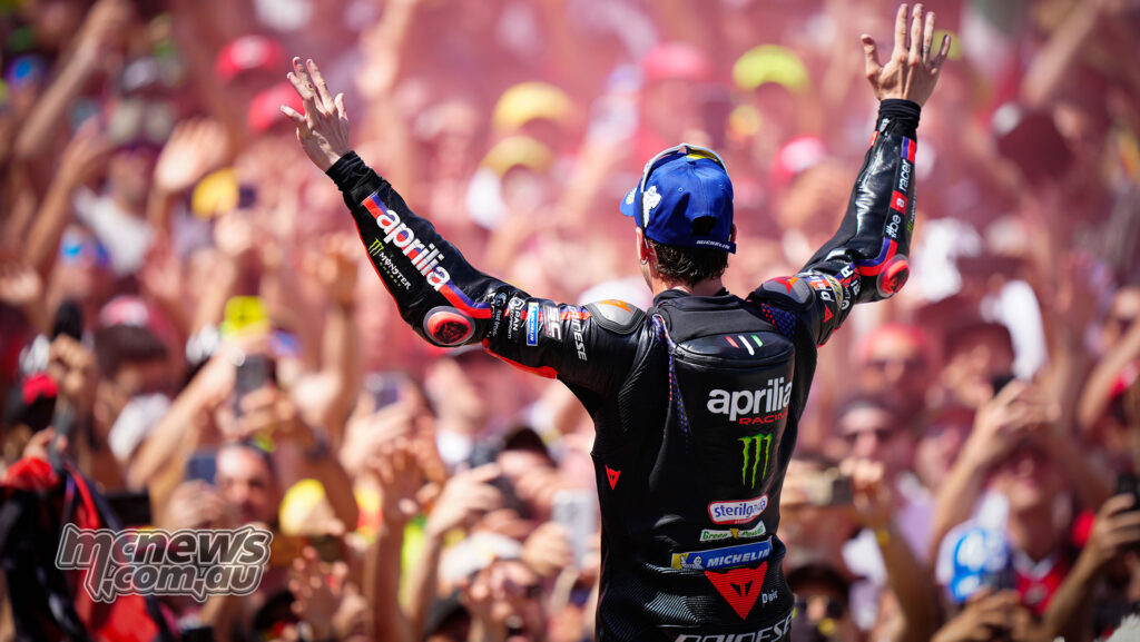 Marco Bezzecchi raises both arms to the Mugello crowd after winning the Italian Grand Prix.