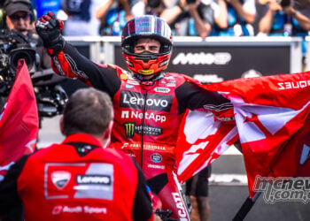 Marc Marquez celebrates with a red flag after his Hungarian MotoGP victory.