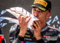Senna Agius kisses his Moto2 podium trophy after the Hungarian Grand Prix.