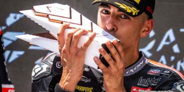 Senna Agius kisses his Moto2 podium trophy after the Hungarian Grand Prix.