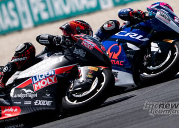 Two Moto2 riders lean through a tight left-hand corner at Balaton Park.