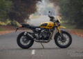 Yellow Triumph Scrambler 400 XC side profile showing spoked wheels, engine and exhaust.