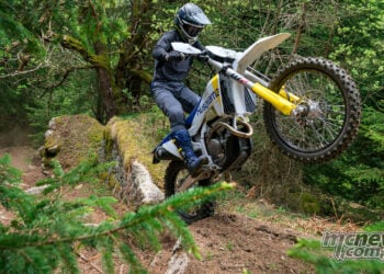 2027 Husqvarna FE enduro motorcycle climbing a rocky forest trail