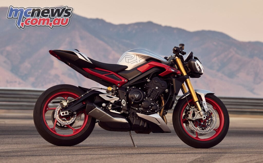 Side profile of the 2026 Triumph Street Triple 765 RX showing red wheels and RX graphics