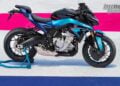 Full side profile of the 2026 CFMOTO 675NK GP Champion Blue on a race-themed display surface.