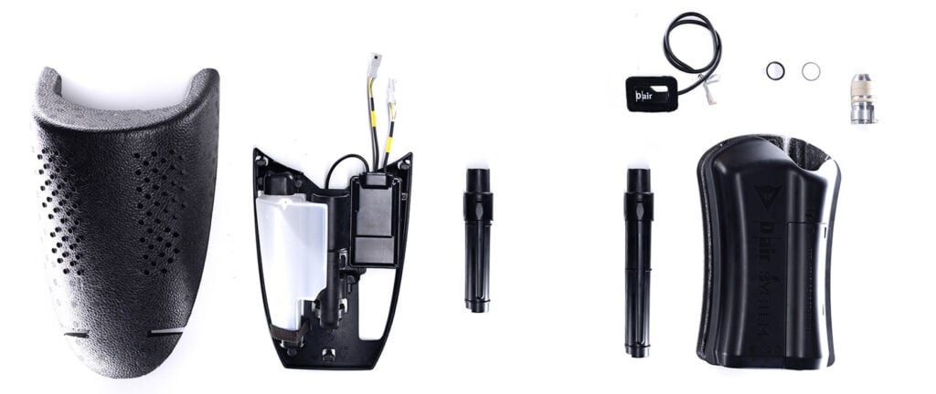 Dainese D-air components including electronic modules, gas generators and protective shells displayed on a white background.