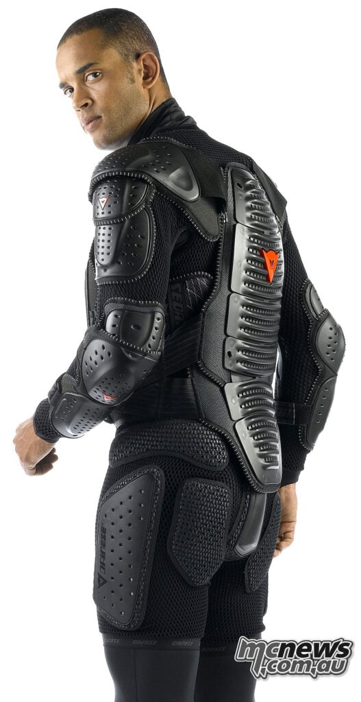 Model wearing a black Dainese Wave protective jacket with back, shoulder and elbow armour.