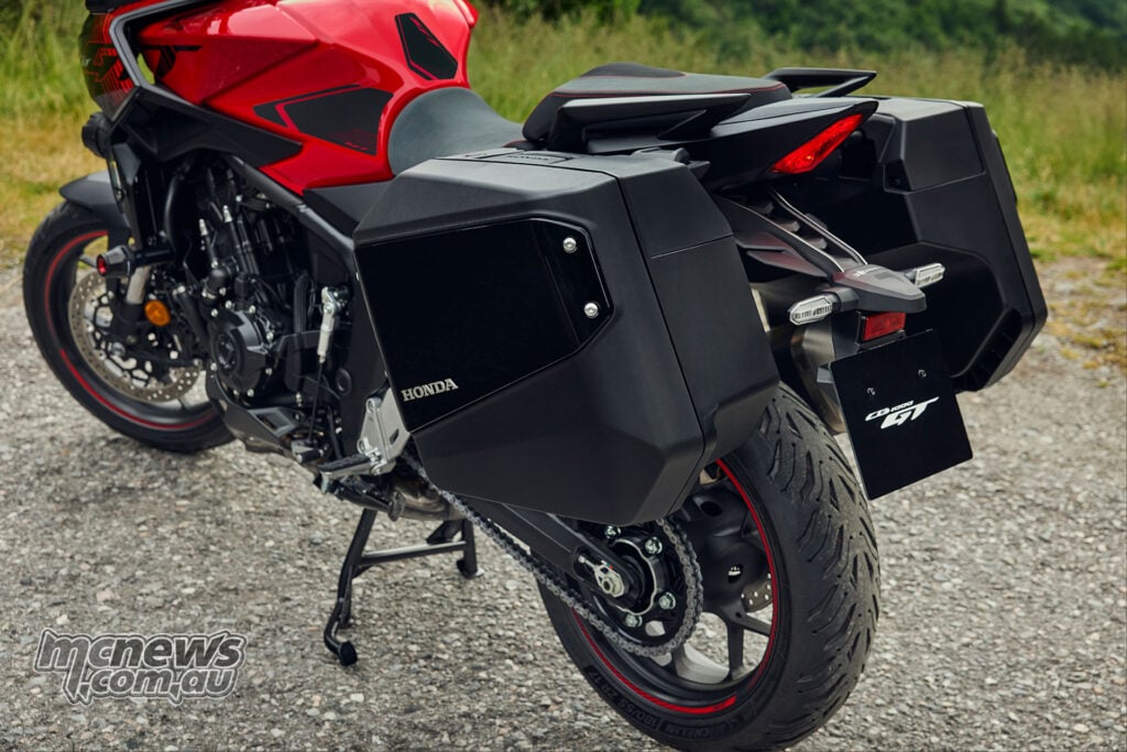 Rear three-quarter view of the 2026 Honda CB1000GT showing its detachable hard panniers, rear wheel and centre stand.