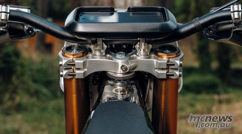 Close-up of the numbered CNC aluminum triple clamp and handlebar display on the Stark VARG Factory Edition.