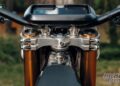 Close-up of the numbered CNC aluminium triple clamps and handlebar display on the Stark VARG Factory Edition.