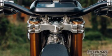 Close-up of the numbered CNC aluminium triple clamps and handlebar display on the Stark VARG Factory Edition.