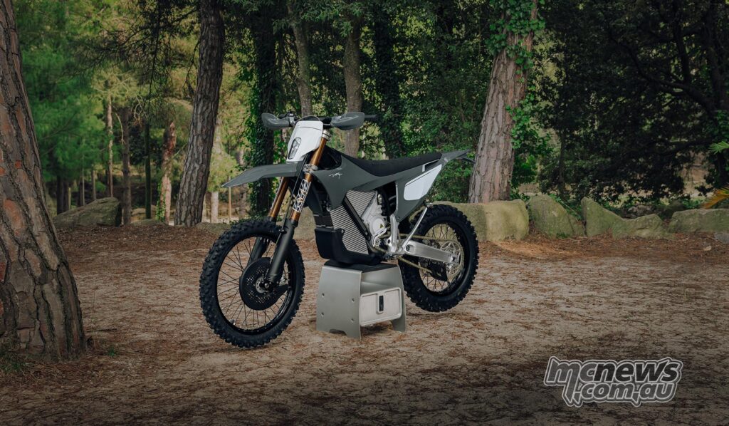 The Forest Gray Stark VARG EX Factory Edition is displayed on a stand among the trees.
