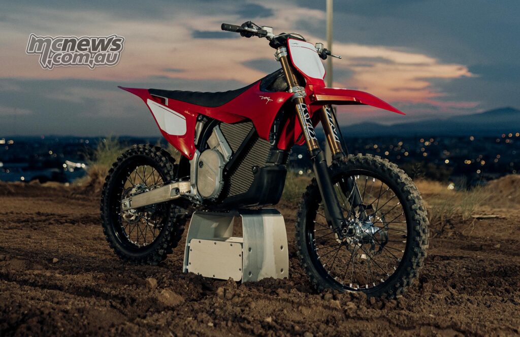 Front three-quarter view of the red Stark VARG MX Factory Edition on a stand at dusk.