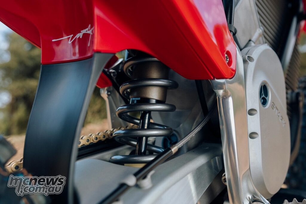 Close-up of the rear suspension spring and shock assembly on the Stark VARG MX Factory Edition.