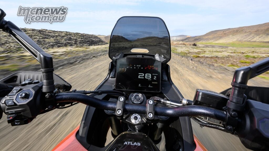 Rider’s-eye view over the Norton Atlas handlebars, eight-inch TFT display and windscreen while moving.