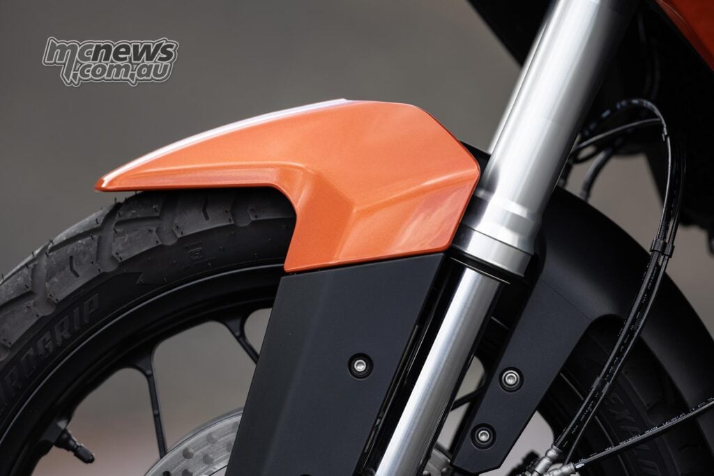 Close-up of the orange Norton Atlas front mudguard above the Eurogrip front tyre.