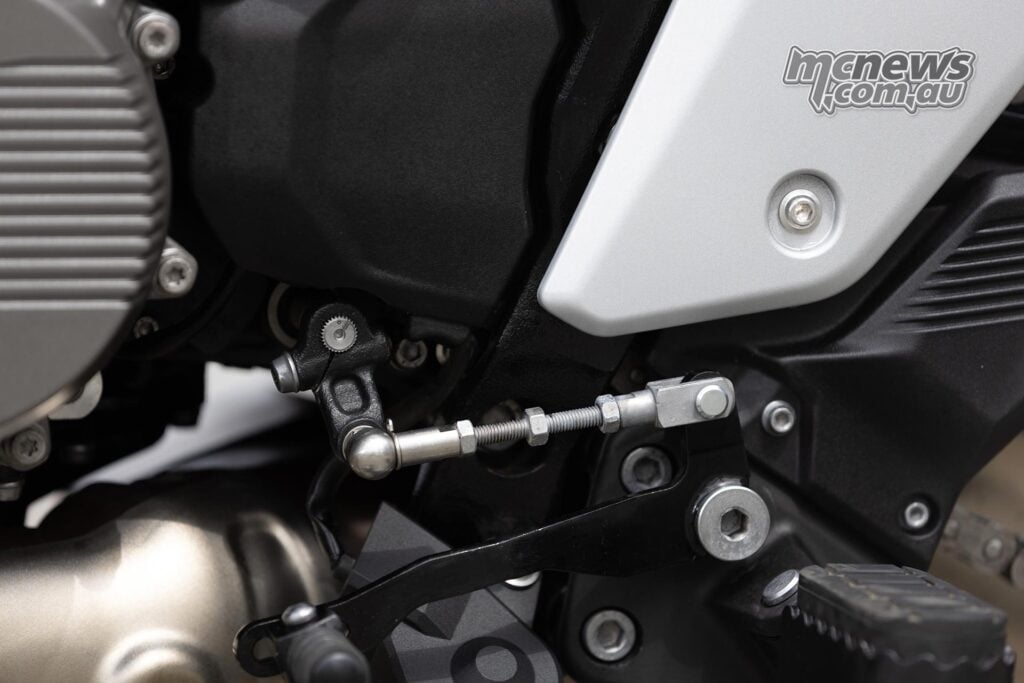 Close-up of the Norton Atlas gear lever and quick-shifter linkage.
