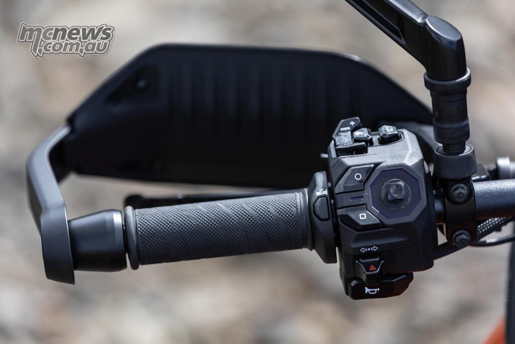 Close-up of the Norton Atlas left handlebar switchgear, heated grip control and handguard.