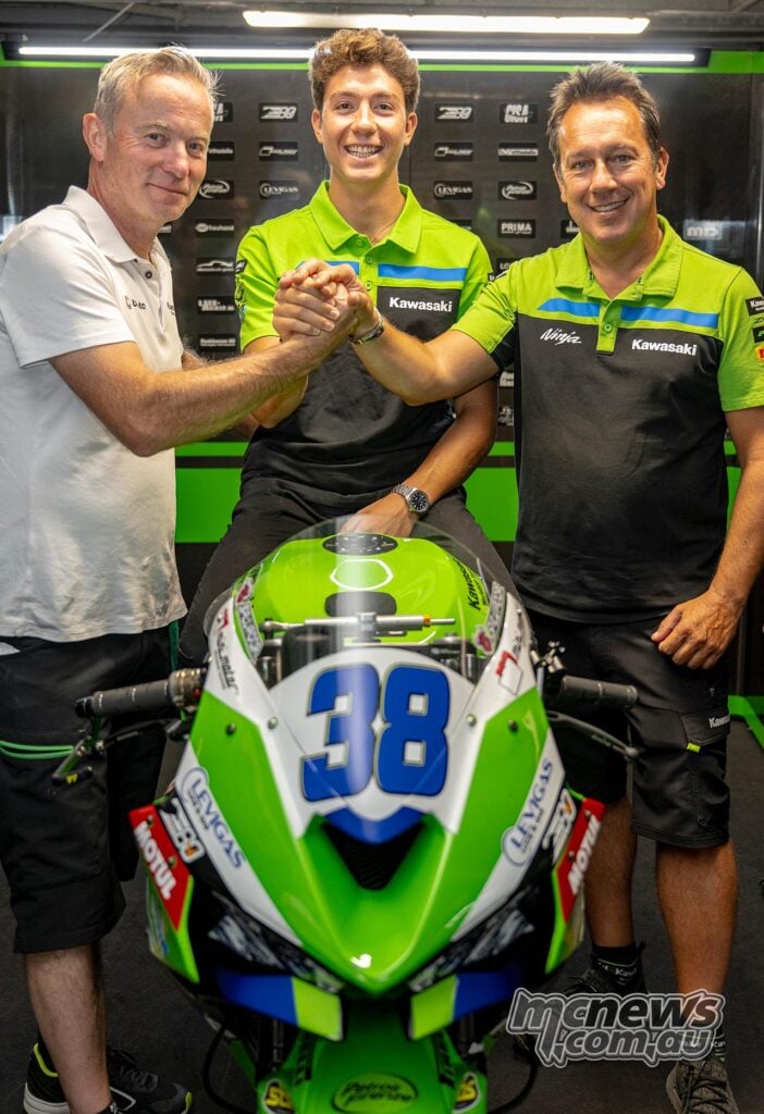Steve Guttridge, David Salvador and Manuel Puccetti shake hands behind Salvador’s number 38 Kawasaki Ninja race bike.