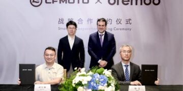 CFMOTO and Brembo representatives seated and standing at a strategic cooperation signing ceremony.