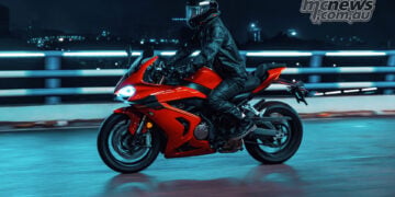 Red QJMOTOR SRK 800 RR sportsbike being ridden at night