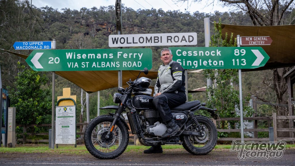 Low-angle view of Trev riding a black BSA Scrambler 650