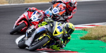 Oli Bayliss leans the number 68 Triumph through a corner ahead of Luke Stapleford and Jack Kennedy at Oulton Park.