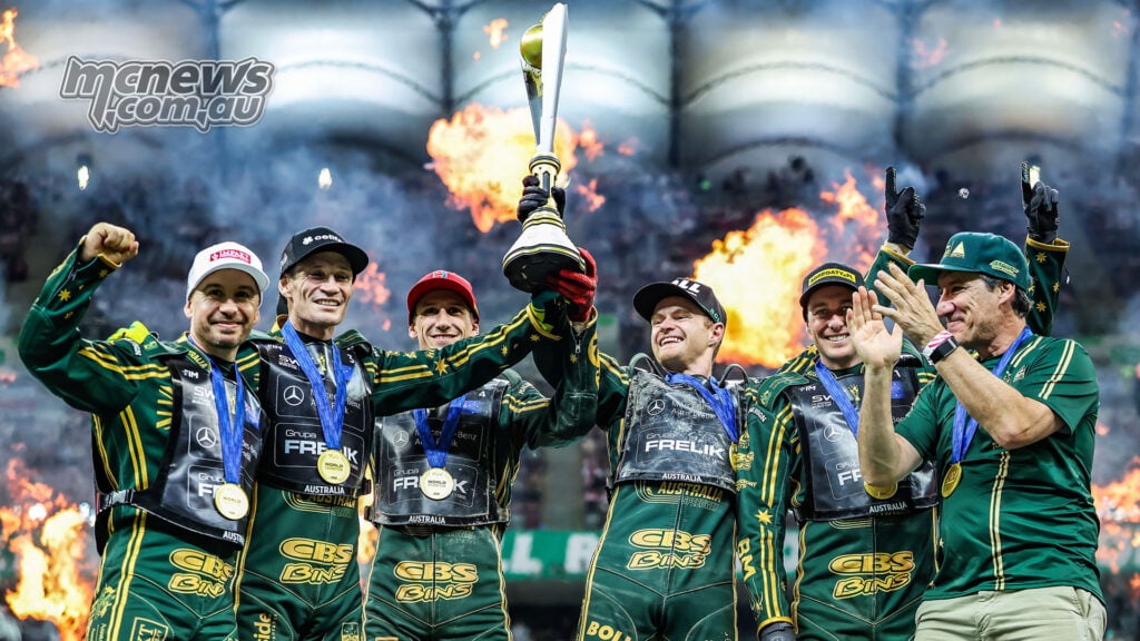 Team Australia raises the 2026 Speedway World Cup trophy beneath the Warsaw pyrotechnics.