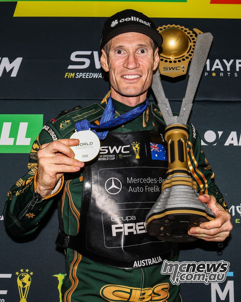 Jason Doyle celebrates with his Speedway World Cup gold medal and the championship trophy.