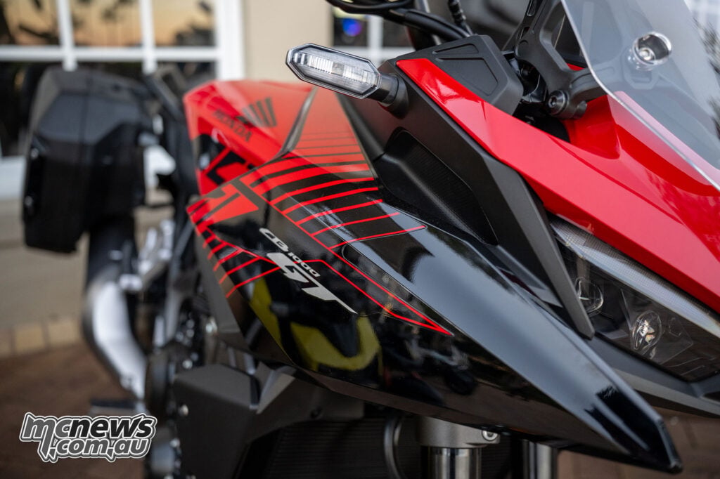 Close-up of the Honda CB1000GT LED indicator, angular front fairing, aerodynamic duct and headlight.
