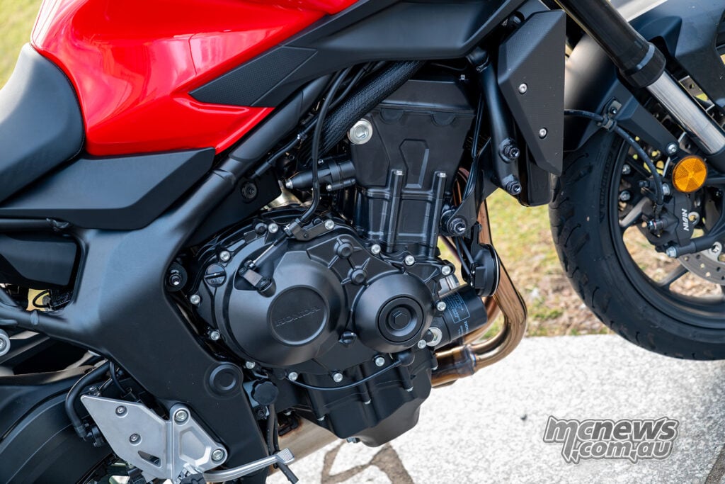 Right-side close-up of the Honda CB1000GT inline-four engine, frame and exhaust headers.