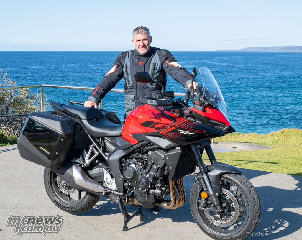 Trevor Hedge standing beside the red 2026 Honda CB1000GT.