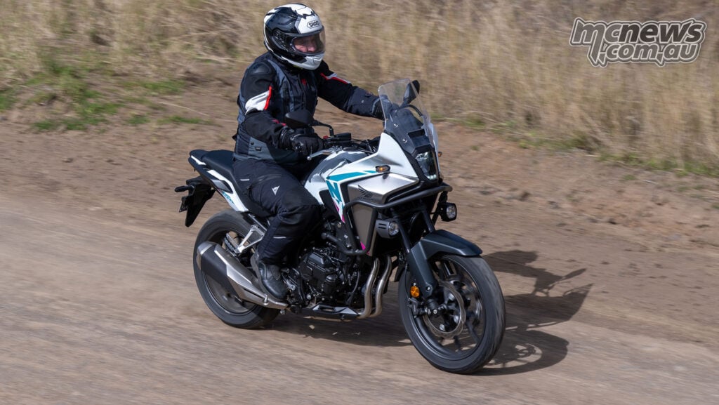 Elevated front three-quarter view of Trevor Hedge riding a white Honda NX500