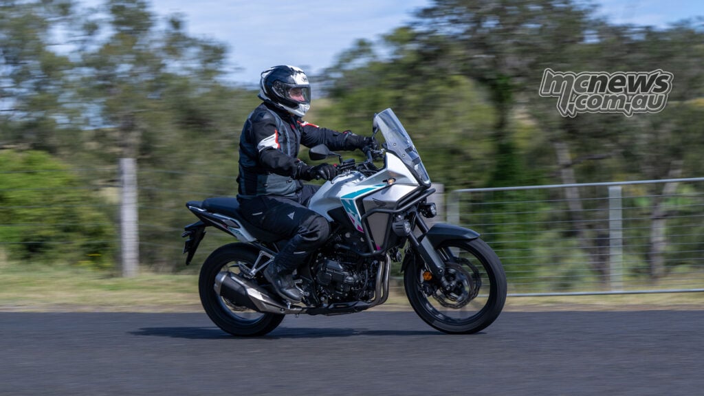 Side view of Trevor Hedge riding a white 2026 Honda NX500
