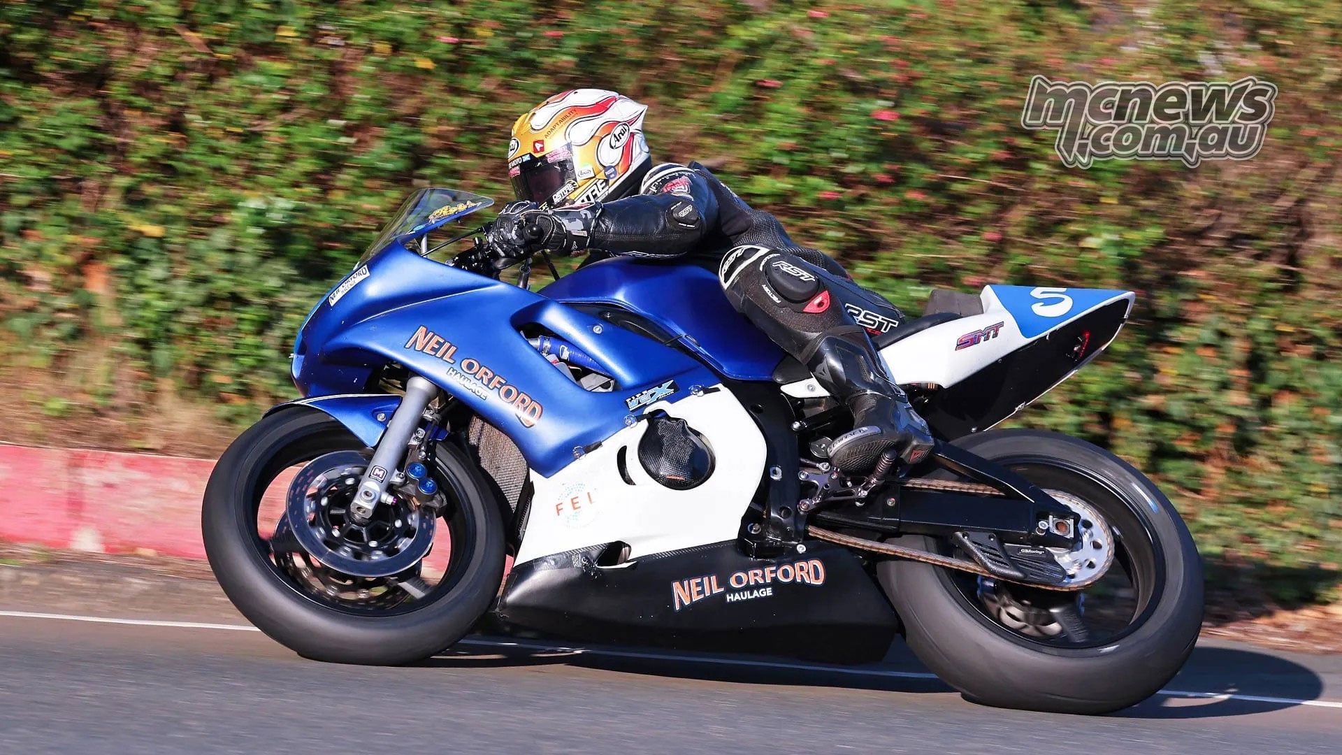 Rob Hodson rides his blue number five Yamaha through a road-course bend